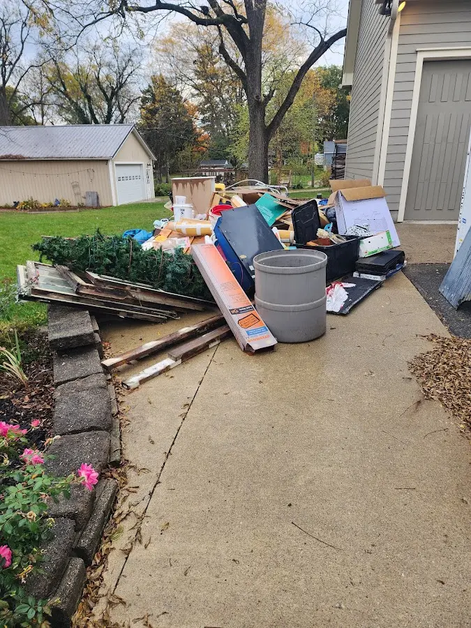 Dumpster being loaded with debris for Demolition Dumpster Rental in Lloyd Harbor